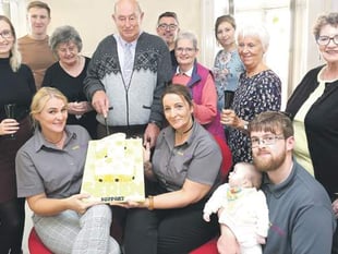 Staff and care users mark first birthday in offices