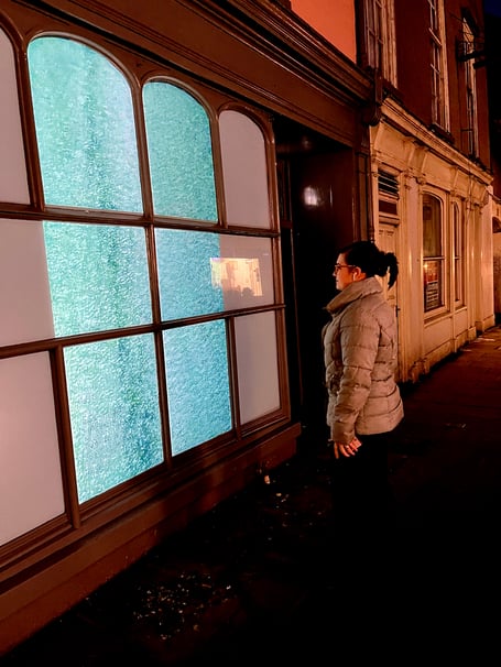 A passerby enjoys the digital art on High Street, Brecon.