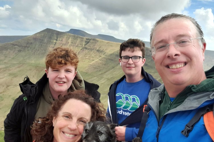 Laine Skinner with wife Sara, sons Aneurin (14, back left), Brynach (15 back centre), and family dog Scamp.