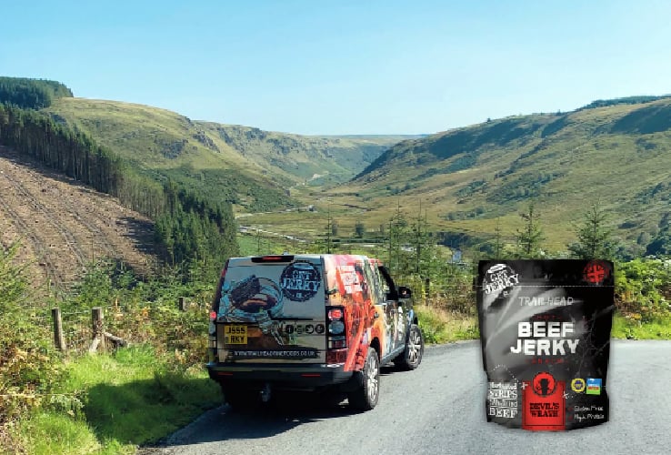 A Get Jerky branded Land Rover with the Devil’s Staircase in the background