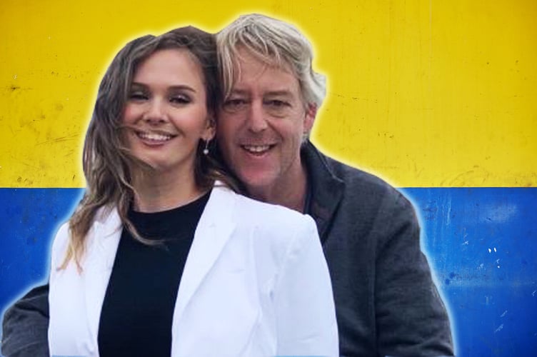 Graham and Alla Blackledge over a Ukraine flag painting