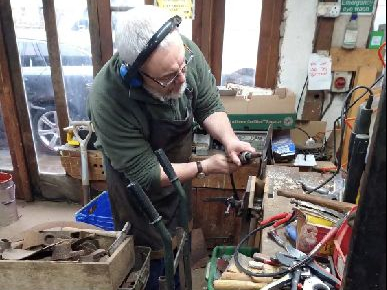 TFSR Cymru volunteer, Frank Olding, refurbishing some of the second-hand tools.