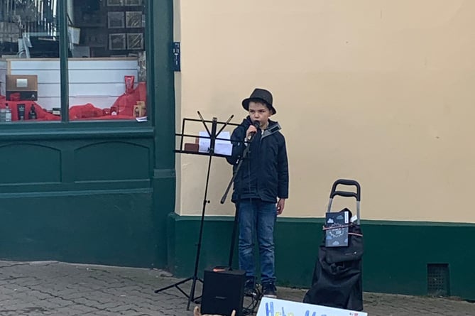George busking to raise money for refugees
