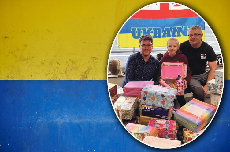 Ebony Slade pictured with Cllr Dorrance (left) and dad Paul (right), Dixies Corner director, with the boxes.