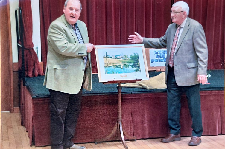 Mr Evan Morgan presenting Malcolm with the framed photograph
