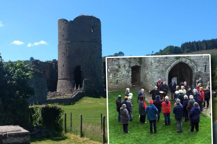 Dr David Robinson explaining some features of Tretower Court to members of the Brecknock Society inset over a photo of the old court ruins