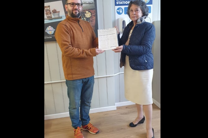 Cllr Rosemarie Harris, receives the ‘Say Yes to Llanigon Green Space Petition’ from Gwernyfed Community Councillor and campaigner, William Lloyd