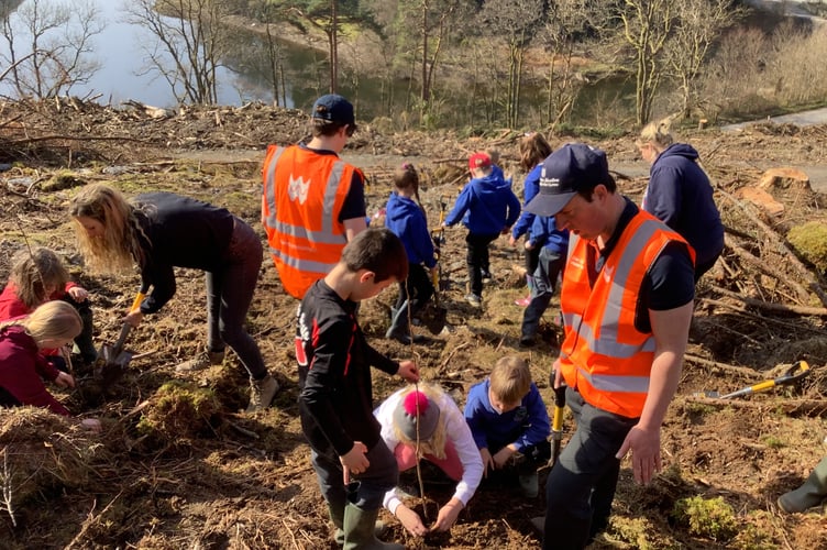Elan Valley Rangers Leighann Briggs and Rob Andrew with school children