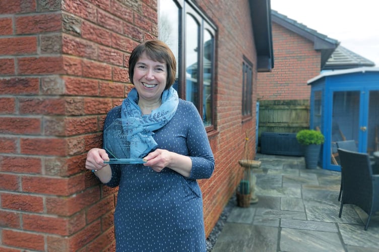 Jan holding her trophy from the awards