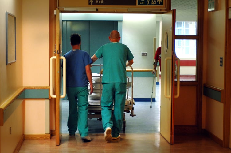 Orderlies push a bed at the Royal Orthopaedic Hospital, Oswestry.