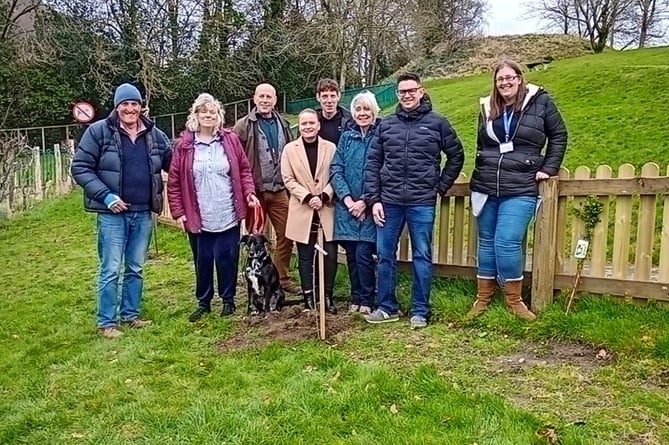 Jane Bradford and her sons together with the Comm trustees, staff and volunteers at the Knighton Community Centre planting on March 9
