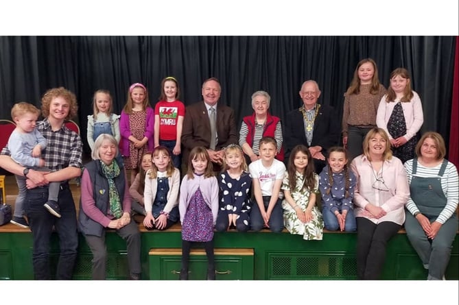 Cllr Peter James, Mrs Susan Price and Cllr Jim Davies pictured with the children who provided the entertainment.