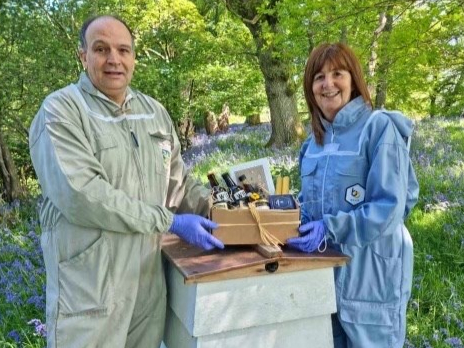 Rural affairs minister Lesley Griffiths with Shane Llewelyn Jones at the Bee Welsh Honey company