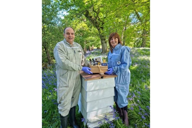 Rural affairs minister Lesley Griffiths with Shane Llewelyn Jones at the Bee Welsh Honey company