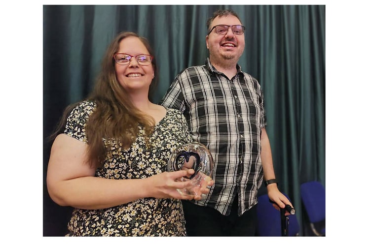 Michelle and Dean beaming with their award 