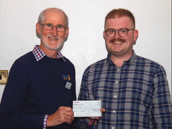 Brecon Rotary president Roger Reese presenting the first place prize to winner Rhys Evans
