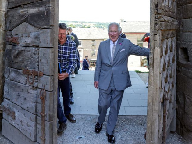 The Prince of Wales officially open Hay Castle by pushing open the oldest gate in situ in the UK in Hay-on-Wye, Powys, Wales. Picture date: Thursday July 7, 2022.