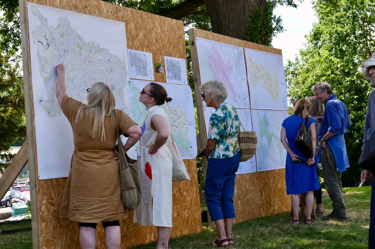People examine maps of the river catchment