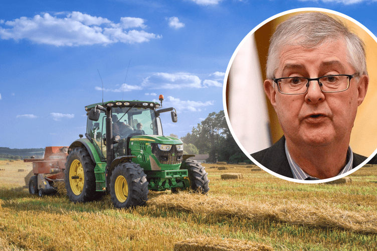 First Minister Mark Drakeford with tractor behind