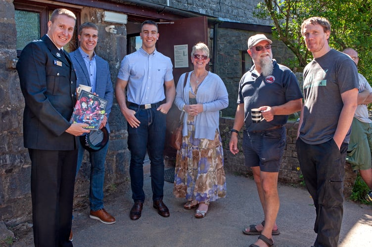 Chief Inspector Pitt holding Descent, with his family, George Linanne on the right and a team member