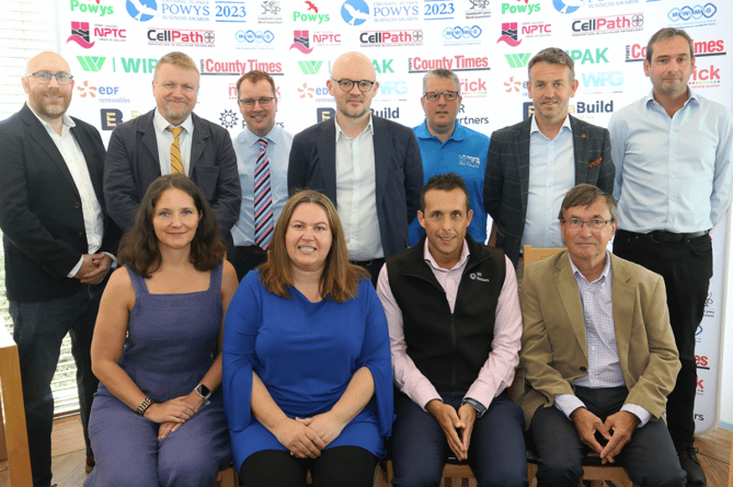 Councillor David Selby (seated right) and Mid Wales Manufacturing Group manager Ceri Stephens (seated second from left) with sponsors of this year’s Powys Business Awards at the launch.