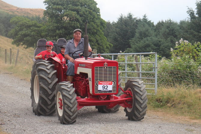 Dave Eady with his grandsons with his International 434
