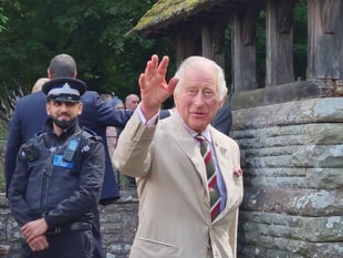Why were King Charles and Queen Camilla at Brecon Cathedral? 