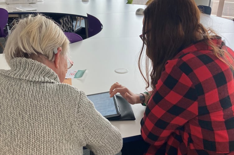 Powys County Council’s Digital Support Officer helping a service user set up with an iPad