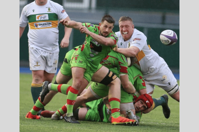 Lee Rees fires the ball away in the 20-10 Premiership win over Merthyr