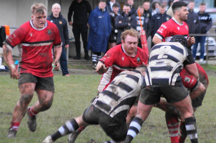 Richie Davies and Owain James give support to their tackled teammate
