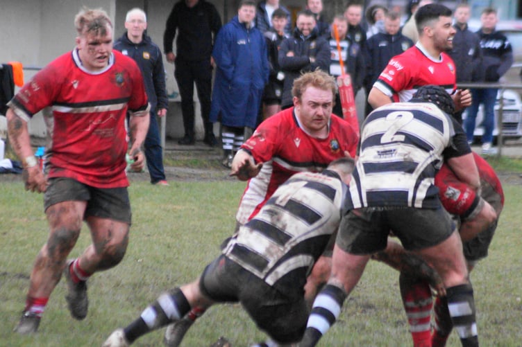 Richie Davies and Owain James give support to their tackled teammate