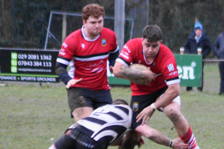 Logan McIntosh drives through a tackle