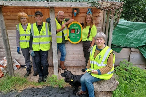 Jackie Charlton and volunteers at Llangattock Woodlands with the new defibrillator