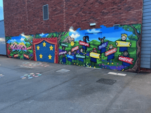 Graffiti artist helps pupils create mural for Powys school