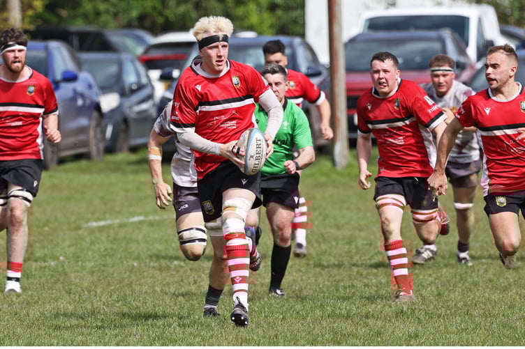 The distinctive figure of Geraint Powell breaks from deep within his own half