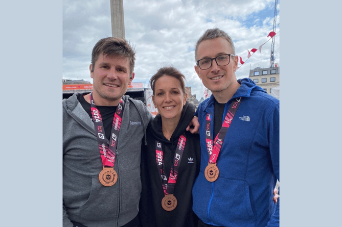 Ed Lewis (right) pictured with siblings Chris and Emma after completing the marathon