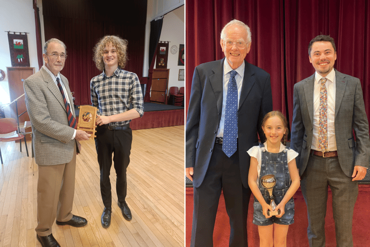Ioan Mabbutt receiving the chair made by Alec Tompkins. Right is Carys Lewis with adjudicators John Meurig and Alex Davies