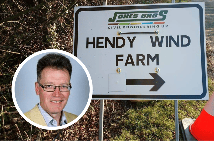 Inset is Cllr Jake Berriman and behind is a sign for Hendy Wind Farm