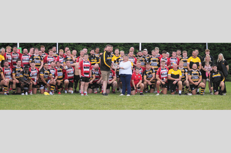 Angharad Woodland, Chair of Brecon RFC, receives a plaque commemorating 150 years of rugby at Newport RFC