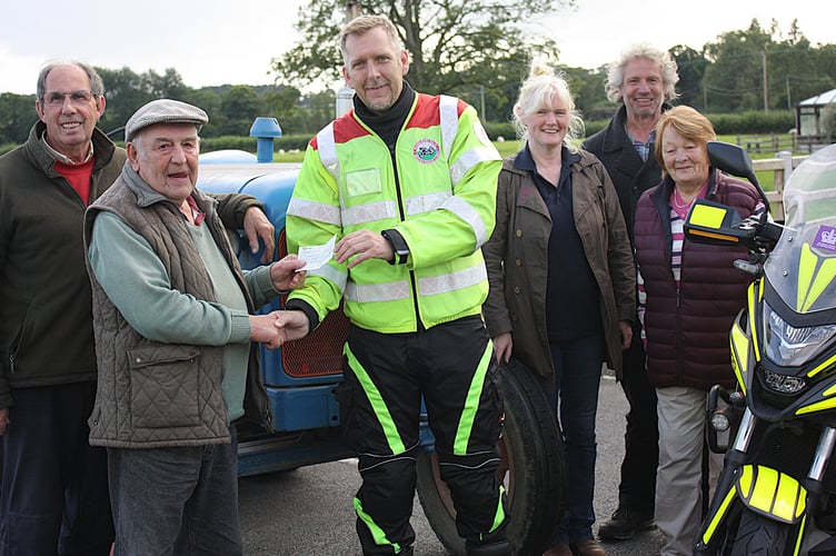 Dennis Davies present Steve Bufton of Blood Bikes Wales with the proceeds of the Llanddewi Tractor Run