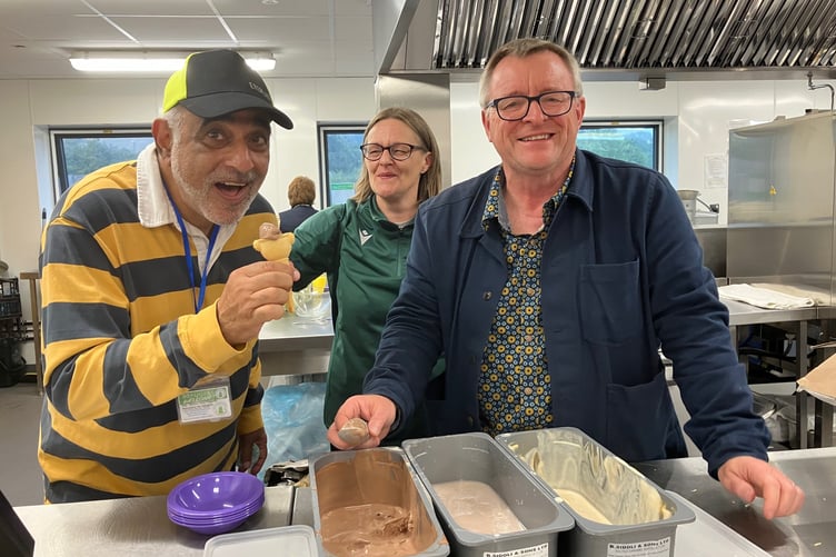 Cllr William Powell, assisted by Cllr Louise Elston-Reeves, serving ice cream to HBTSR trustee Adil Gatrad