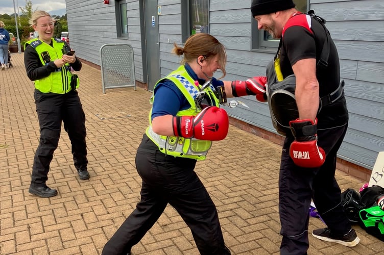 PCSO Vicky Turner having fun with boxing instructor Dave Gilbert, who is also a serving police officer