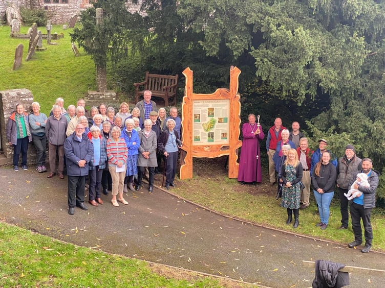 The community with the sign at St Meugan's