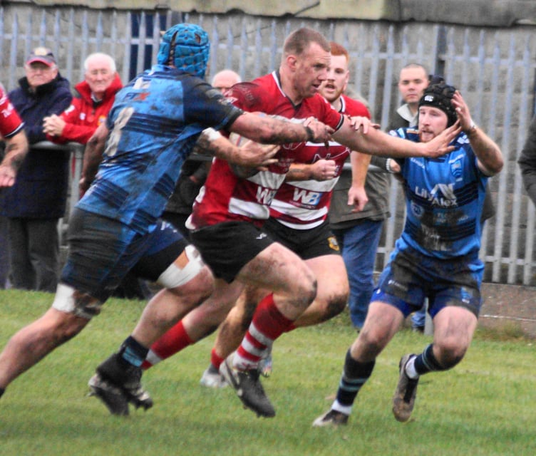 Jack Dixon breaks through a tight Bargoed defence
