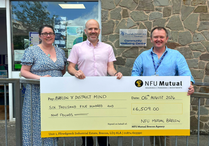 A cheque for £6,500 is presented to Brecon and District Mind, supporting mental health services across the community