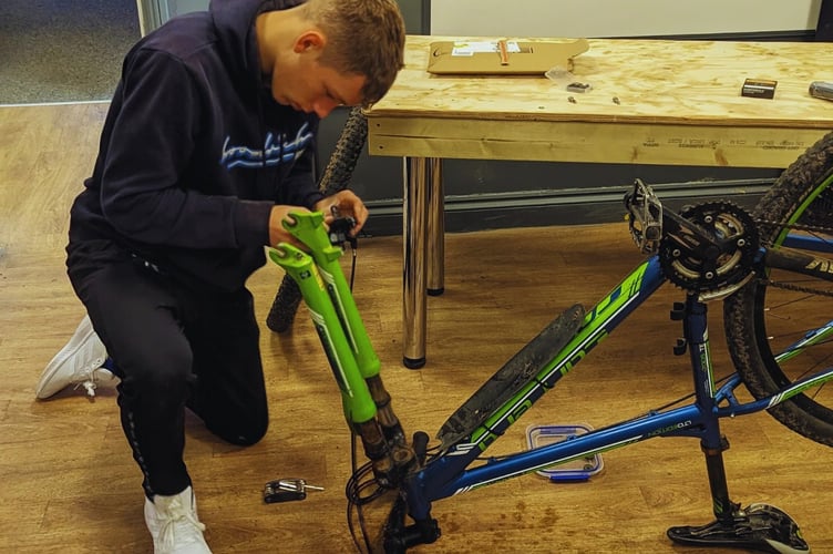 Ysgol Antur Cwm pupil Ieuan Thomas learning about cycle maintenance