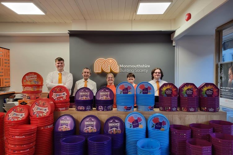 Monmouthshire Building Society staff in Brecon with the plastic tubs collected for the Tub2Pub campaign, helping to raise funds for Macmillan Cancer Support and promote recycling.