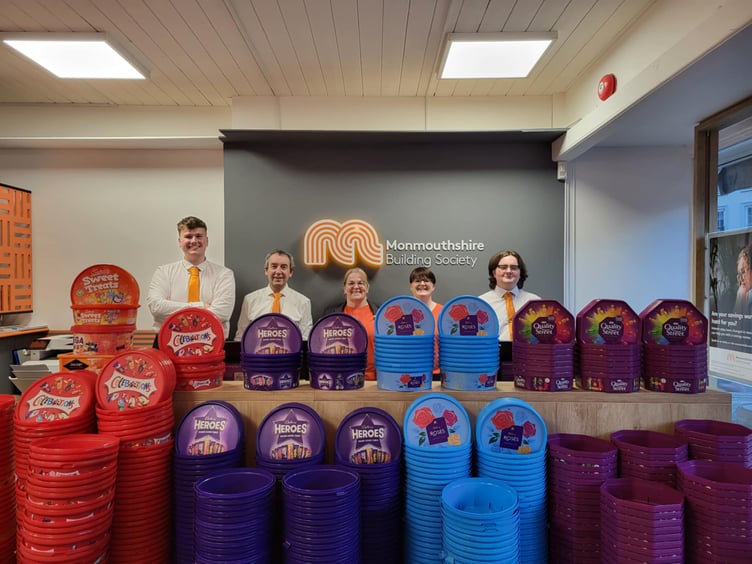 Monmouthshire Building Society staff in Brecon with the plastic tubs collected for the Tub2Pub campaign, helping to raise funds for Macmillan Cancer Support and promote recycling.