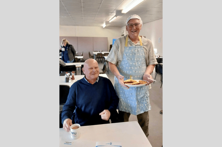 Head waiter John T L serving the first breakfast of the day to Wayne Horne