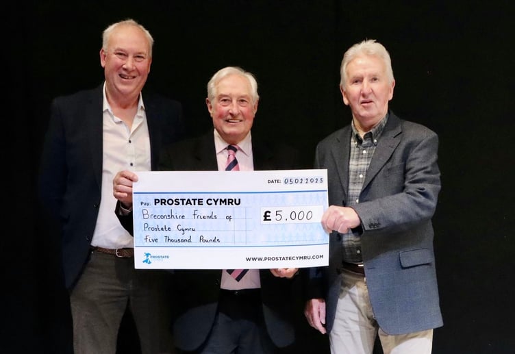Gerwyn Rees and Terry Eckley presenting the cheque to Sir Gareth Edwards